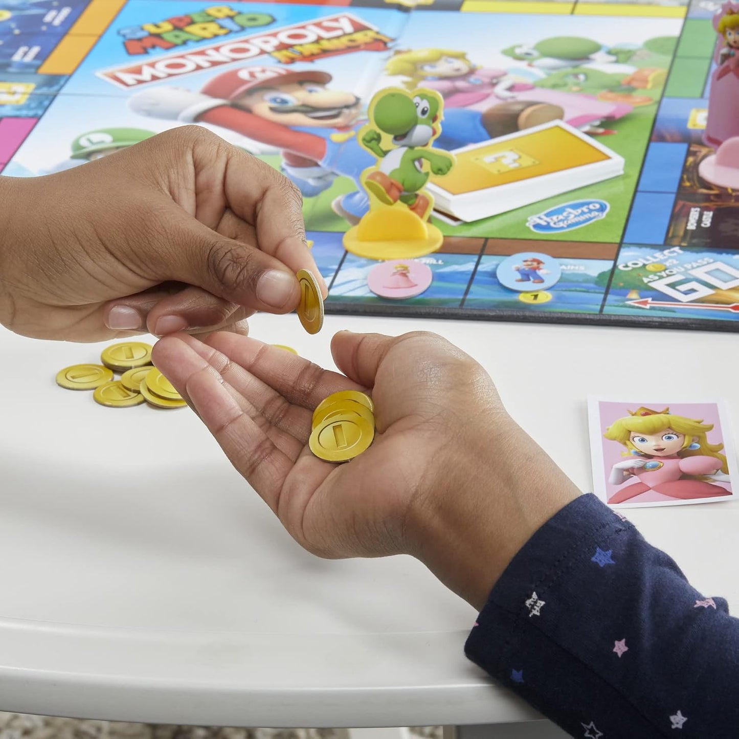 HotMonopoly Junior Super Mario Edition Board Game, Fun Kids' Ages 5 and Up, Explore The Mushroom Kingdom as Mario, Peach, Yoshi, or Luigi (Amazon Exclusive)